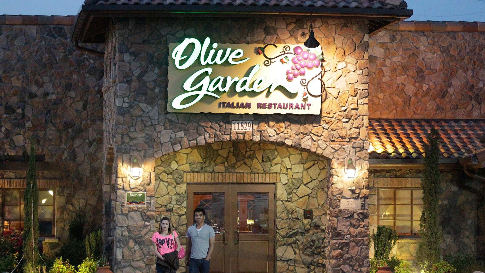 In this May 22, 2014 photo, patrons exit an Olive Garden Restaurant, a Darden restaurant brand, in Short Pump, Va. Darden’s fiscal fourth-quarter profit dropped…