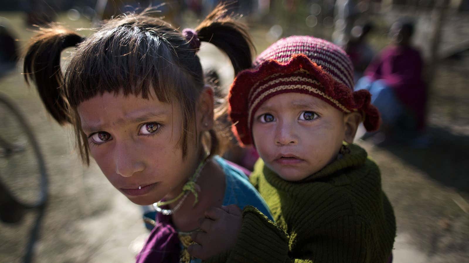 Indian tribal children react to camera at a relief camp at Tinsuti village in Sonitpur district