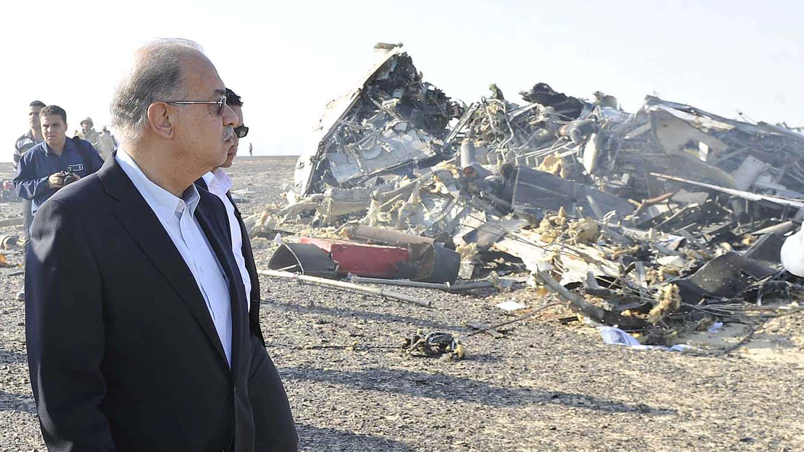 Egypt’s Prime Minister Sherif Ismail looks at the remains of the Russian airliner.