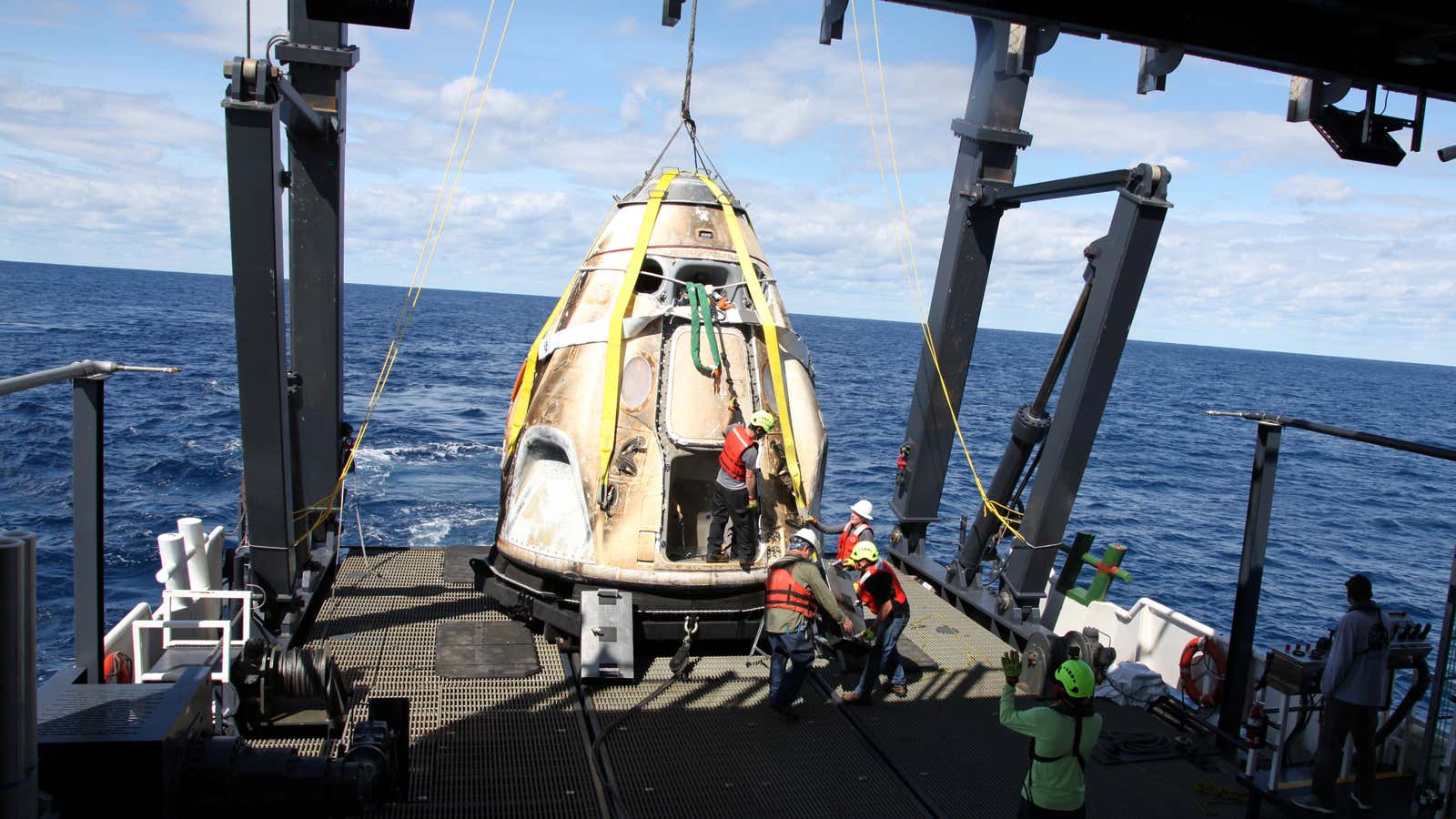 SpaceX workers recover the Dragon spacecraft from the Atlantic after it returned from space in March 2019.