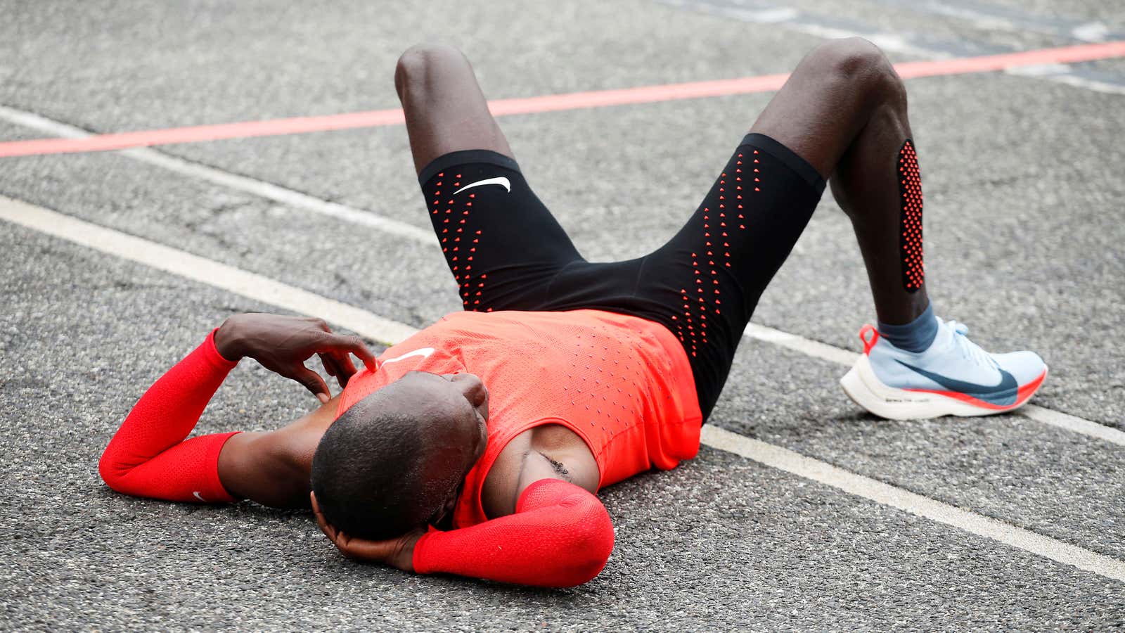 Kenyan Eliud Kipchoge reacts after crossing the finish line during an attempt to break the two-hour marathon barrier at the Monza circuit in Italy, May…