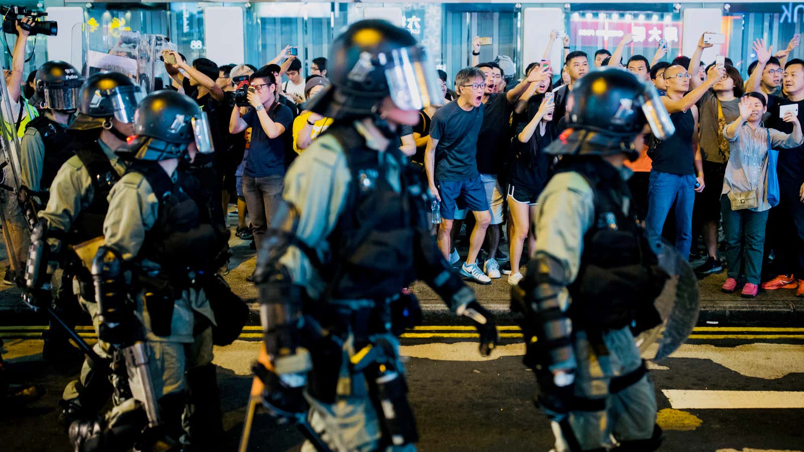 Hong Kong riot police chasing protestors.