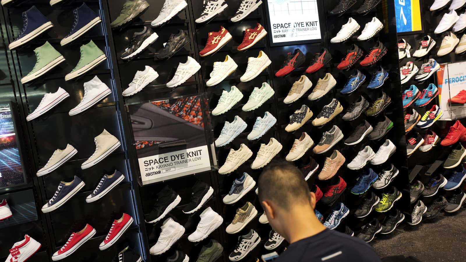 In this Tuesday, Aug. 22, 2017, photo, a customer looks at shoes at a Foot Locker in New York. On Friday, Sept. 15, 2017, the…