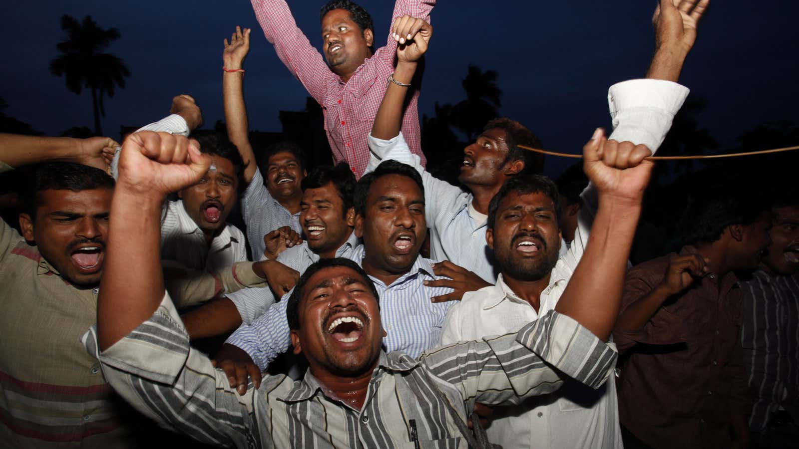 Students of Osmania University celebrate after India’s ruling coalition endorsed the creation of the new state.