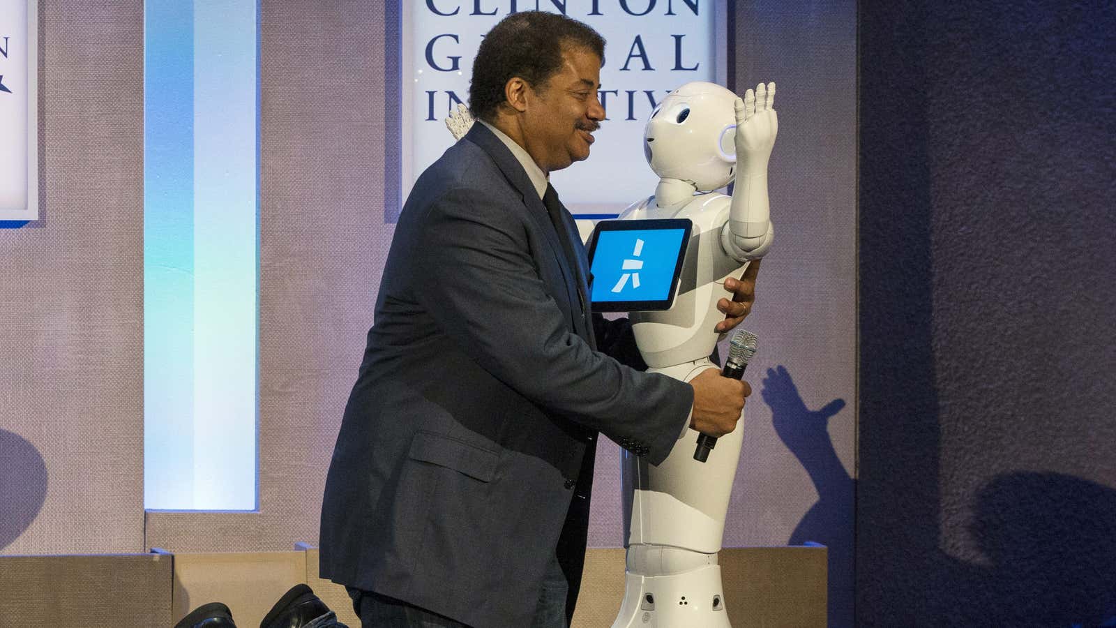 Tyson hugs Pepper, the robot recently fired from a supermarket job for incompetence.