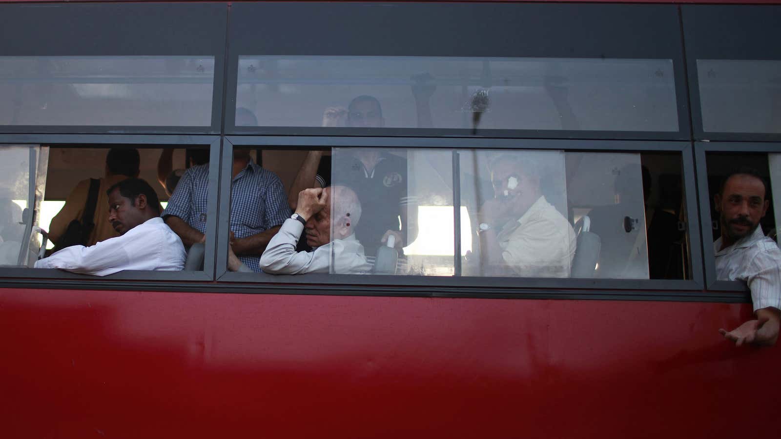 Egyptians ride a bus in Cairo