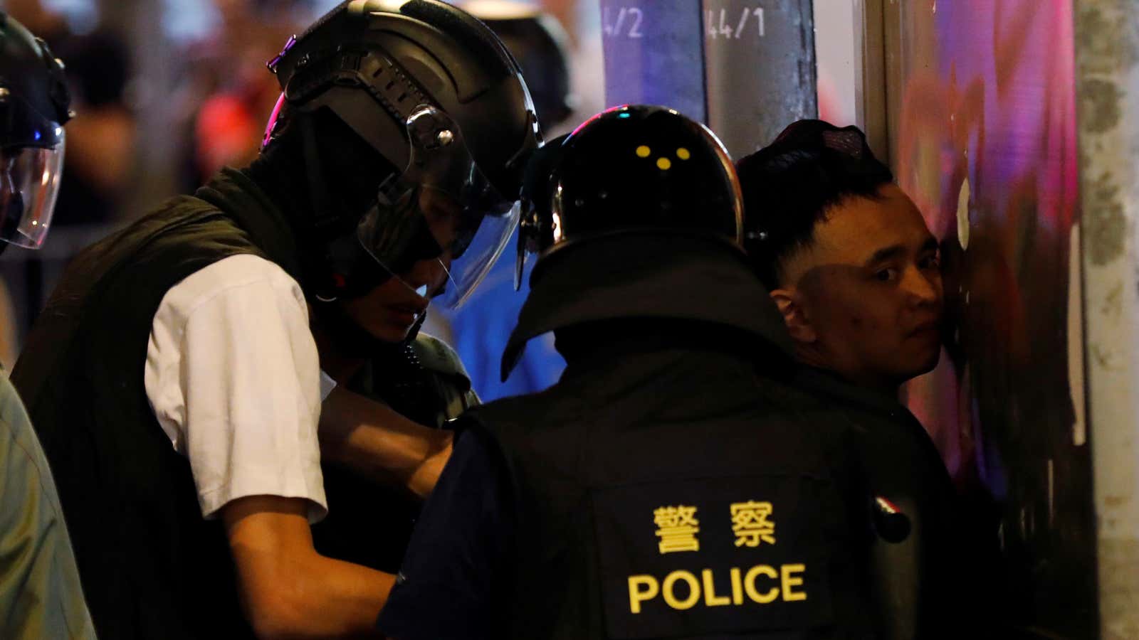 Hong Kong police detain a protestor—a moment captured by the press.