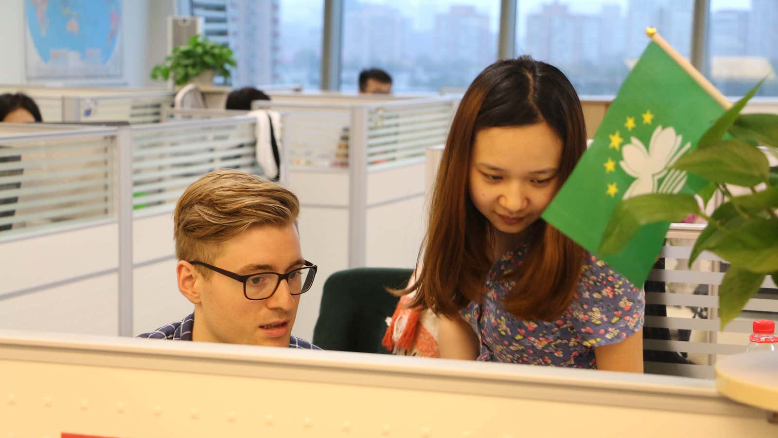 A foreign editor collaborates with his Chinese colleague at the Global Times.