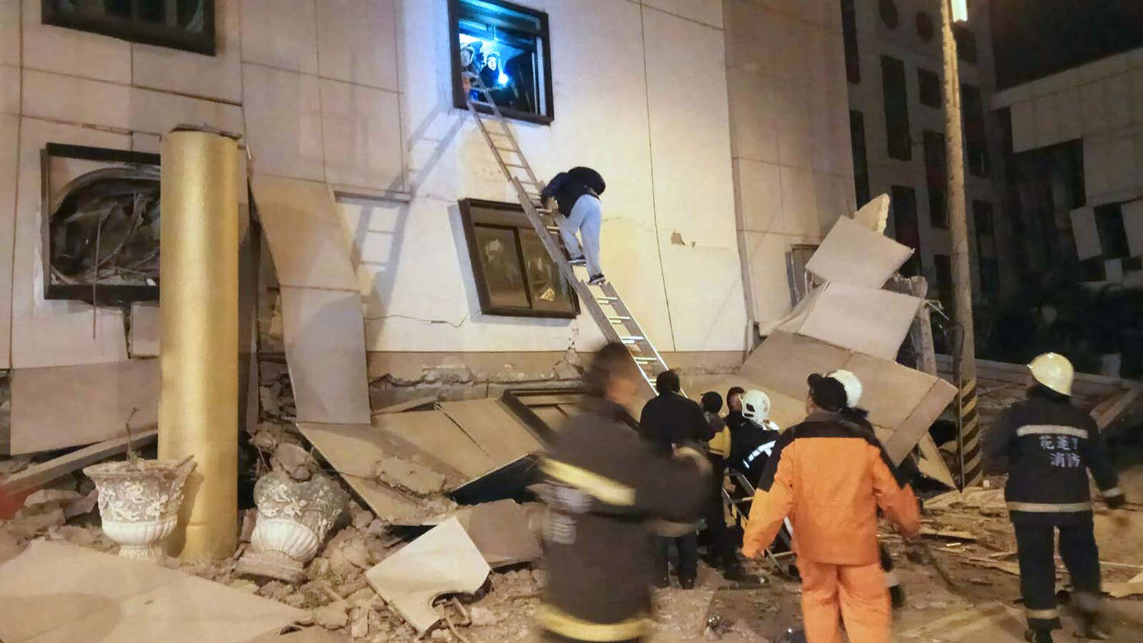 Rescue workers search through rubble outside the Marshal Hotel in Hualien, eastern Taiwan early Feb. 7, after a strong earthquake struck the island.