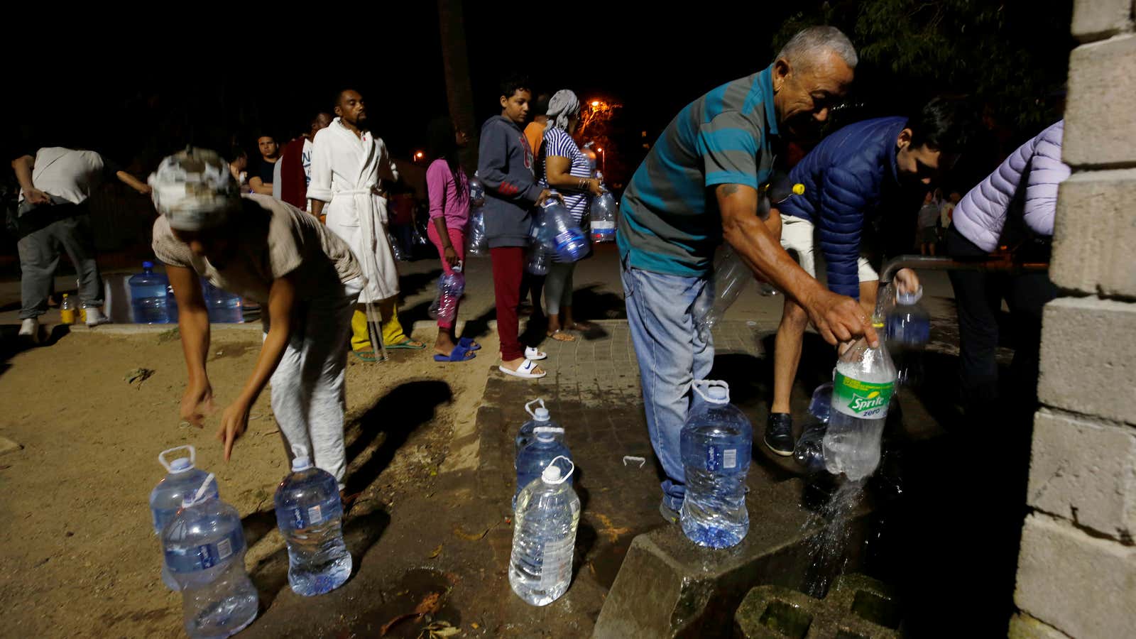 People fill up containers with spring water in Cape Town on Jan. 25, 2018.