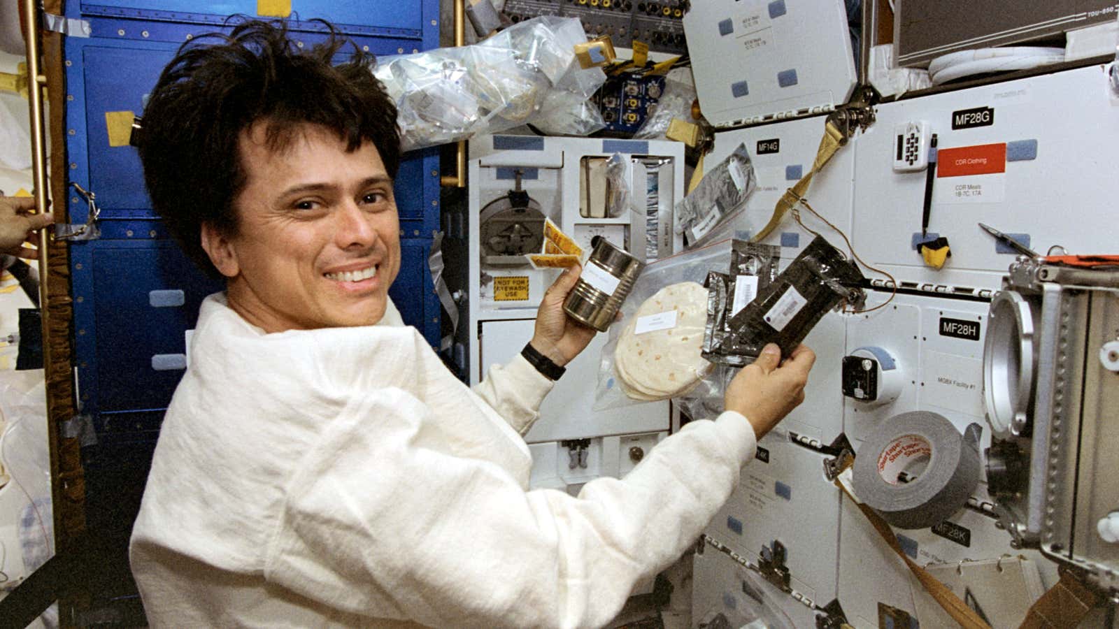 Costa Rican-American astronaut Franklin Chang Diaz prepares a meal during a 1996 space shuttle mission.