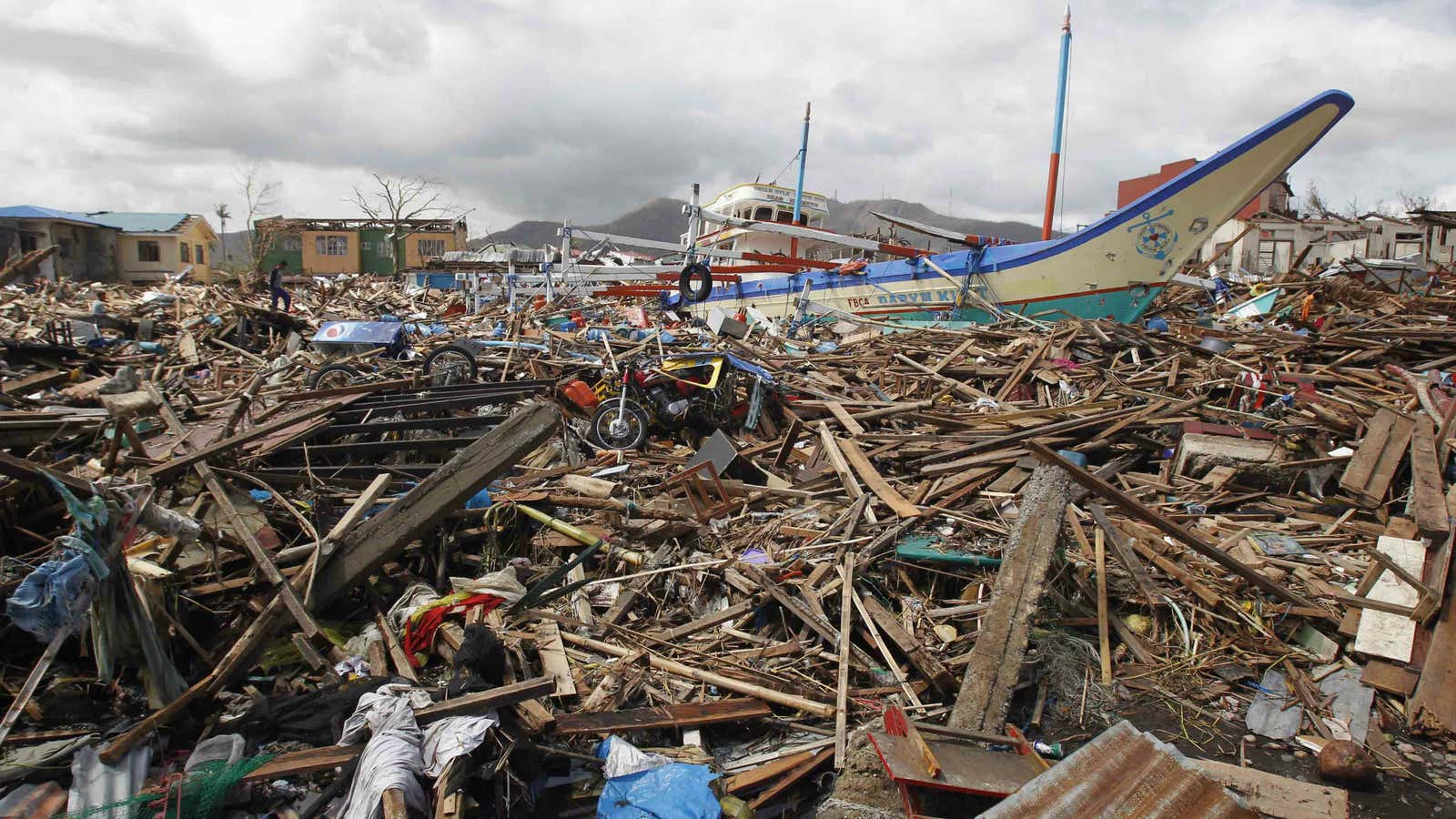 A fishing boat lies atop debris from Typhoon Haiyan in Tacloban.