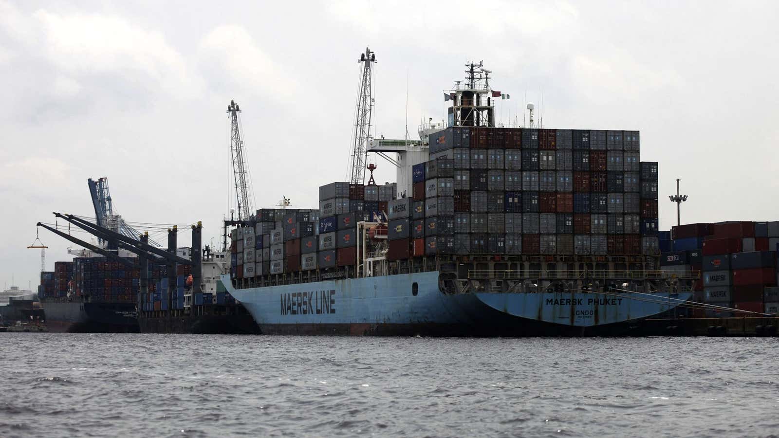 A container vessel berths to discharge containers at Apapa port in Nigeria’s commercial capital Lagos