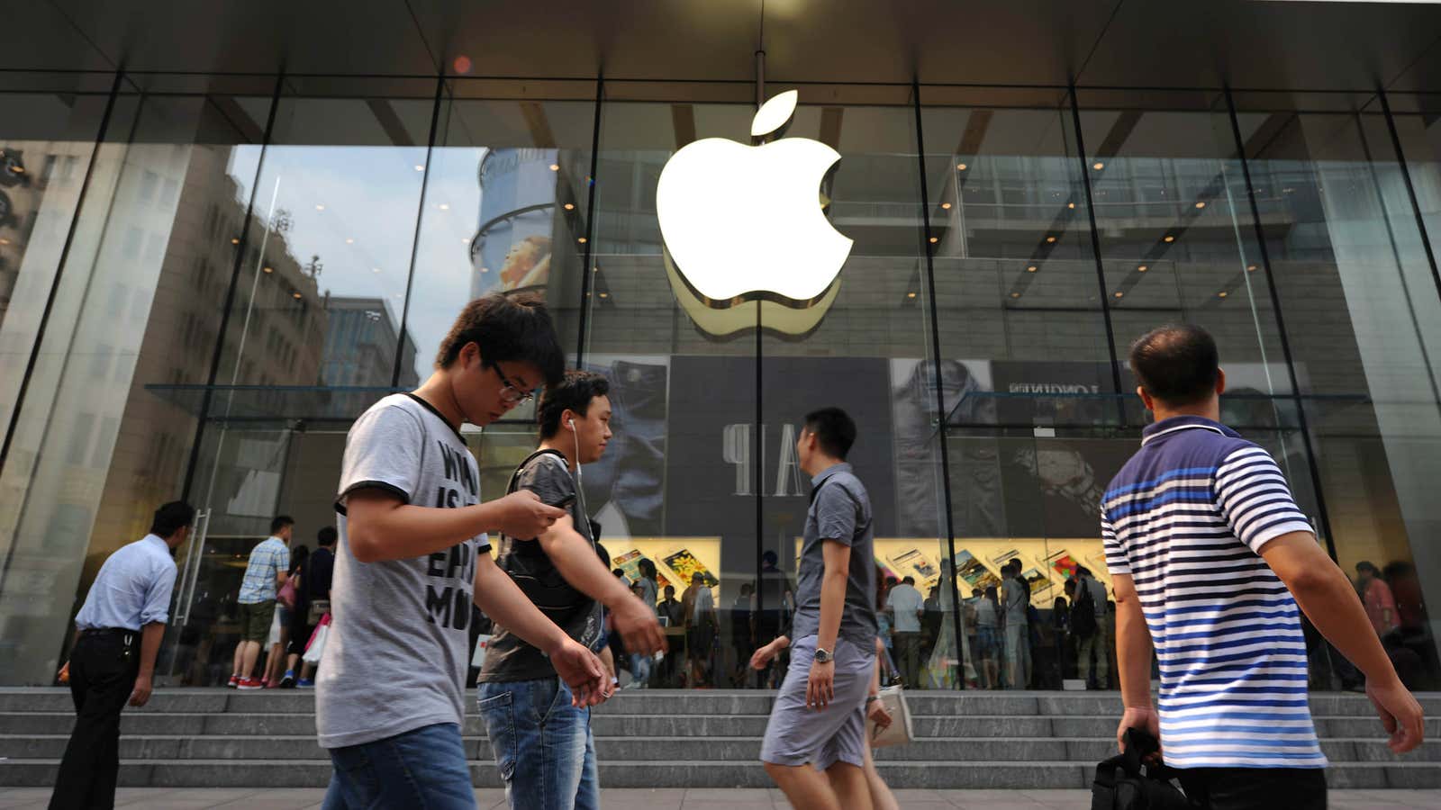 Pedestrians outside an Apple store in Shanghai.