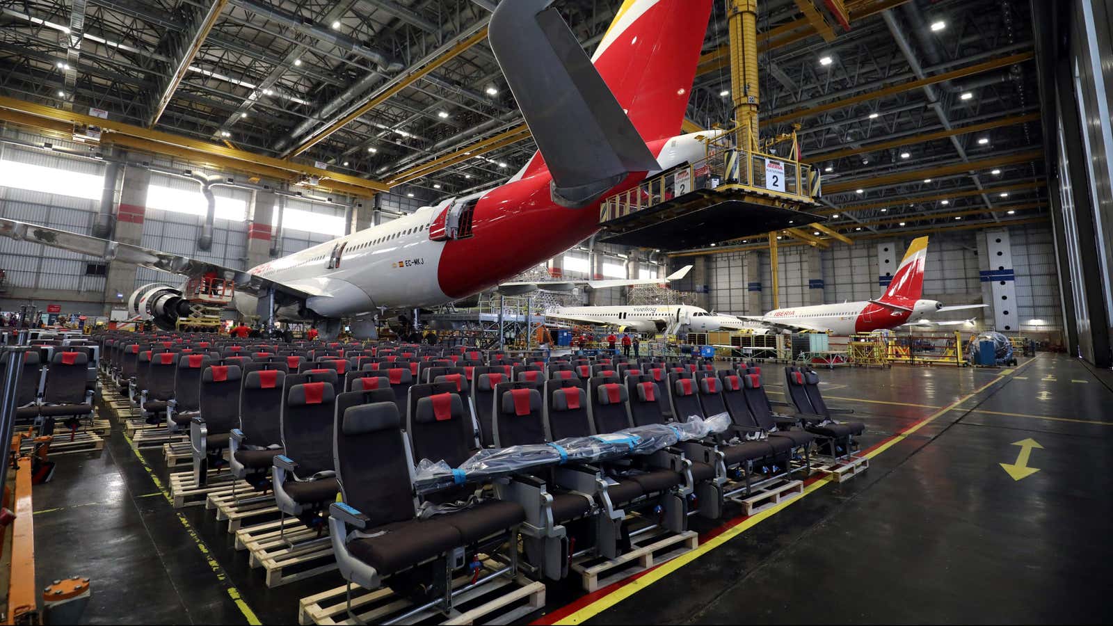 Passengers’ seats are seen under an Iberia’s Airbus 330 which was transformed from a passenger aircraft into a cargo one to face the drop in…