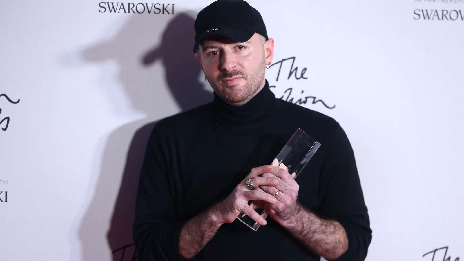 Demna Gvasalia, winner of the International Urban Luxury Brand award poses for photographers at the Fashion Awards 2016 in London, Britain December 5, 2016. REUTERS/Neil Hall – RC14CD40A750
