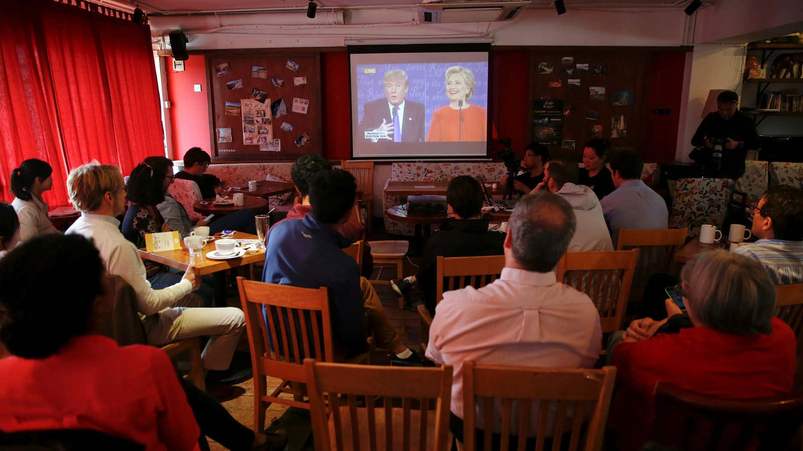 People watch a direct broadcast of the first U.S. presidential debate between Republican U.S. presidential nominee Donald Trump and Democratic U.S. presidential nominee Hillary Clinton…