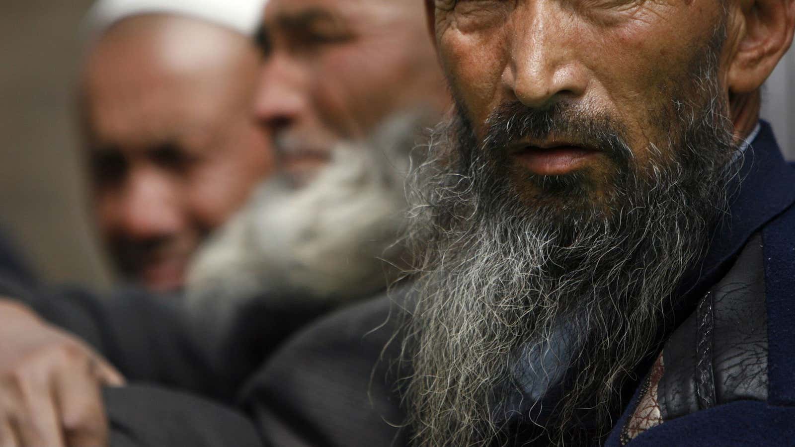 Uighur men wait for the beginning of prayers inside Altyn Mosque in Yarkand, a region of Xinjiang.