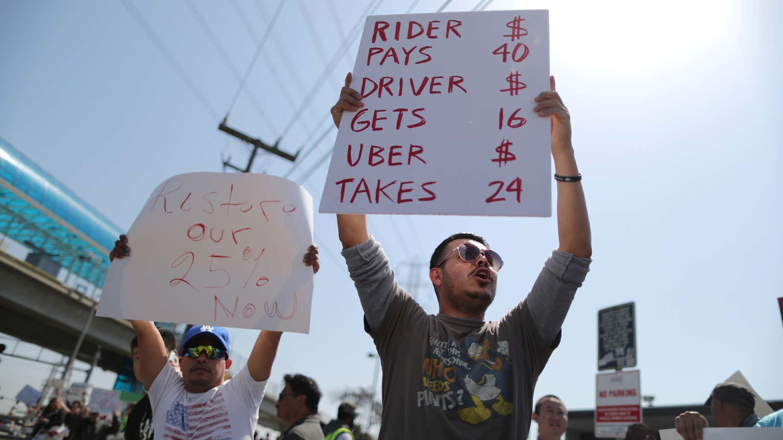 Striking Uber and Lyft drivers protest Uber’s decision to cut per-mile pay from 80 cents to 60 cents, outside the Uber Hub in Redondo Beach,…