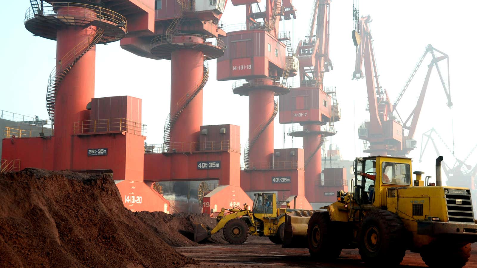 FILE PHOTO: Workers transport soil containing rare earth elements for export at a port in Lianyungang, Jiangsu province, China October 31, 2010. REUTERS/Stringer/File Photo ATTENTION…