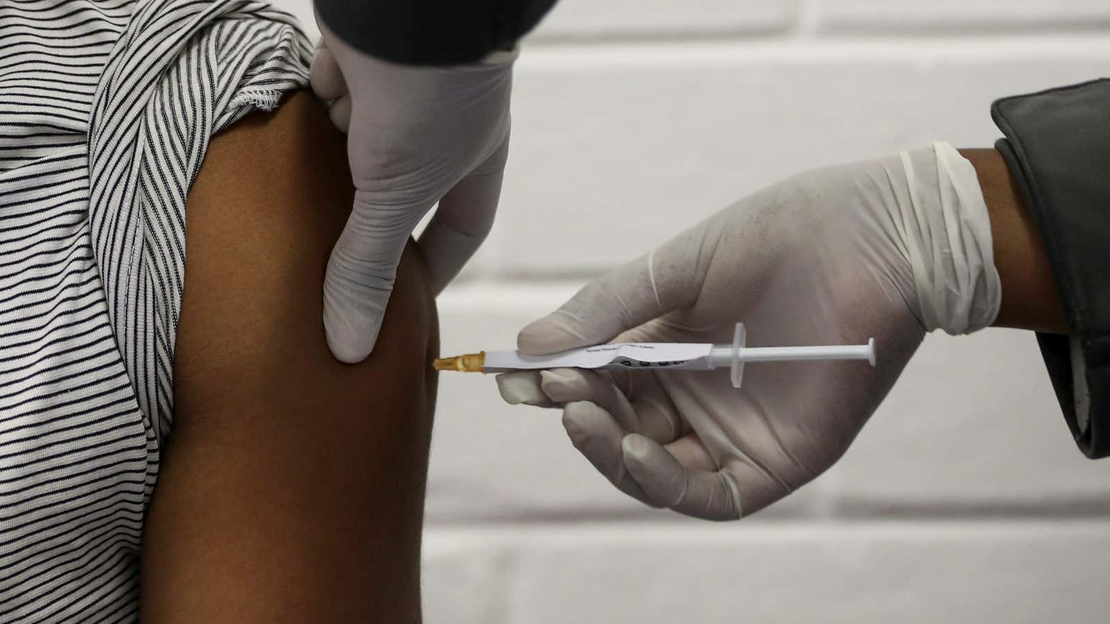 A volunteer receives an injection from a medical worker during the South Africa’s first human clinical trial for a potential vaccine against the novel coronavirus in Soweto, South Africa, June 24, 2020.