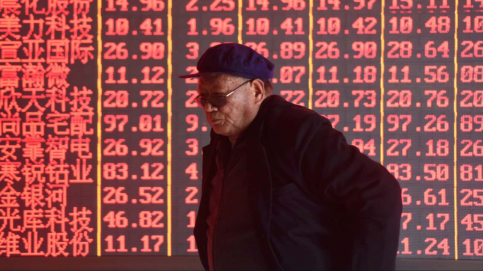A man stands in front of an electronic board displaying stock information at a brokerage firm in Hangzhou, Zhejiang province, China April 1, 2019. Picture…