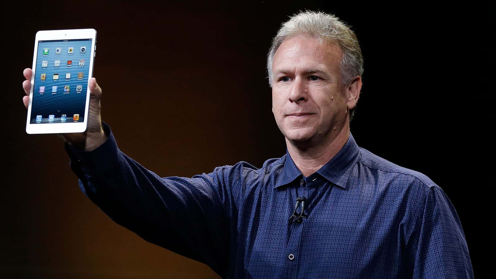 Phil Schiller, senior vice president at Apple, reveals the iPad Mini—with one hand.