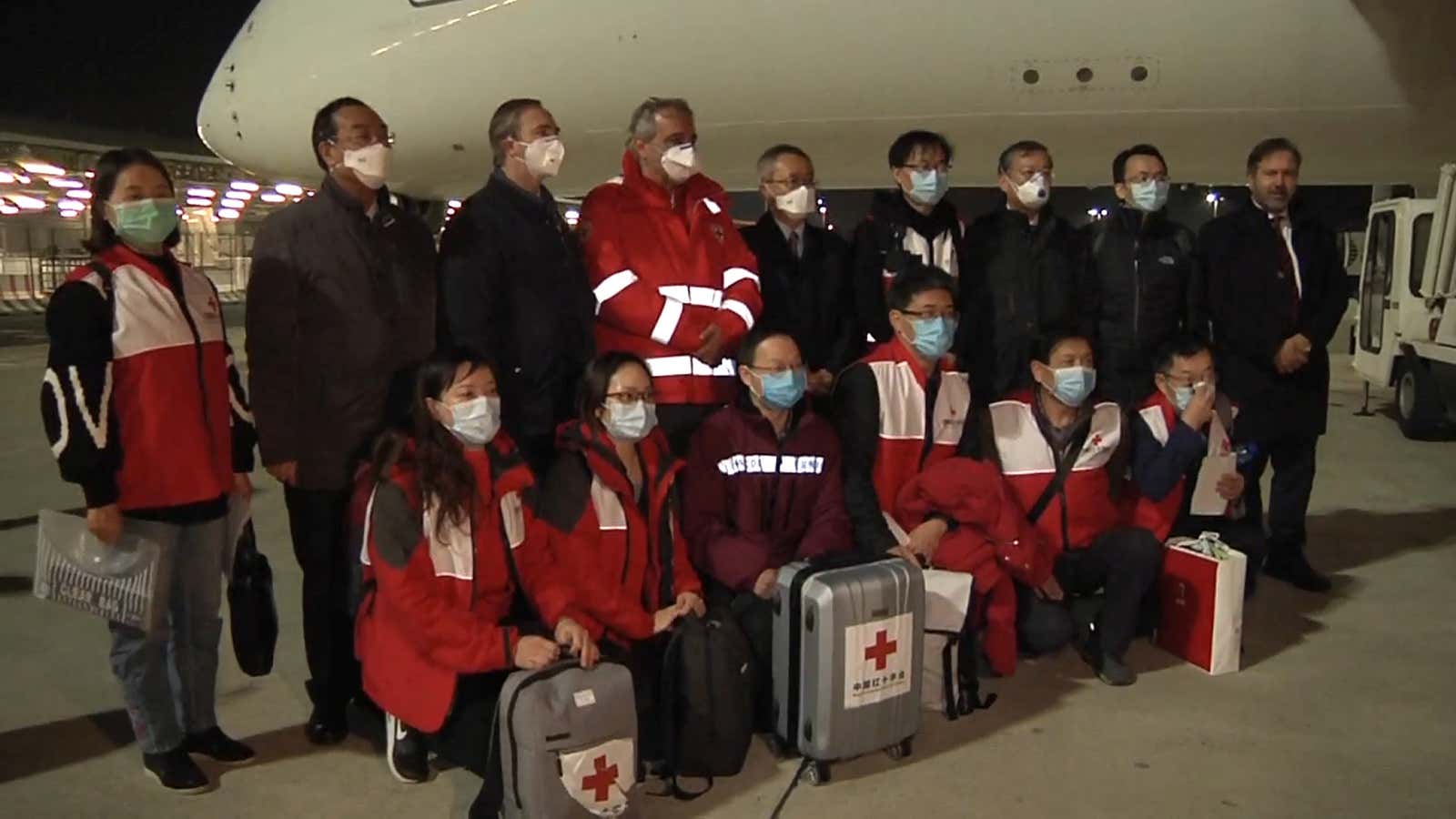 A team of Covid-19 experts from China, carrying supplies. meets the head of the Italian Red Cross at an airport in Rome.