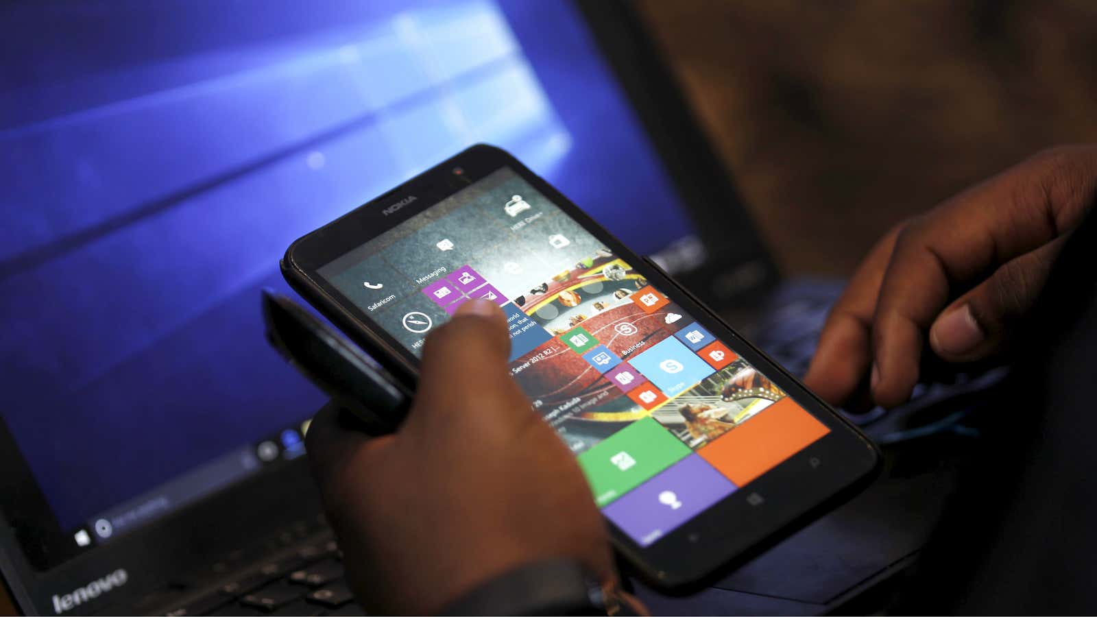 A Microsoft delegate checks applications on a smartphone during the launch of the Windows 10 operating system in Kenya’s capital Nairobi, July 29, 2015