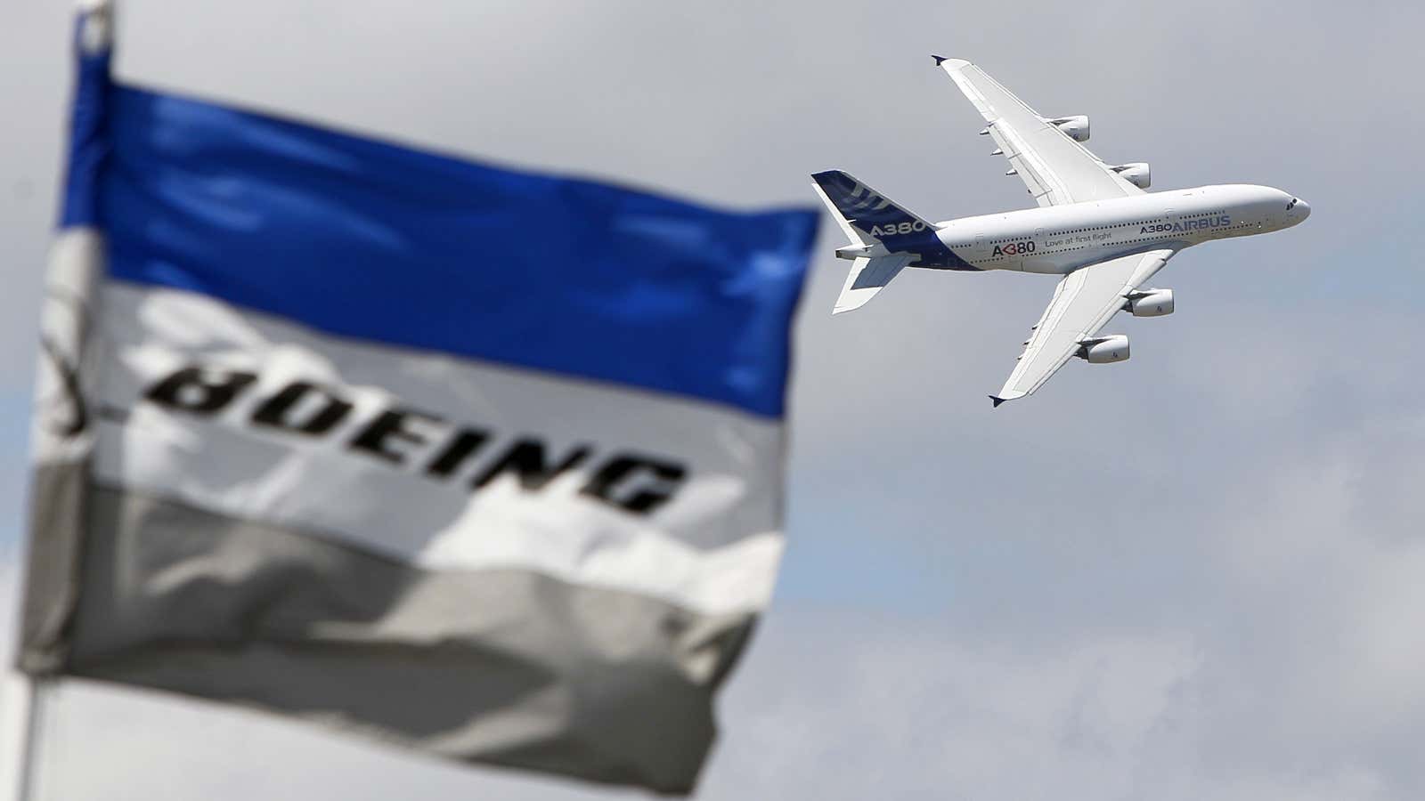 Will the Dreamliner 787’s problems allow Airbus to swoop back into the title of largest aircraft supplier? An Airbus A380 flies by a Boeing sign.