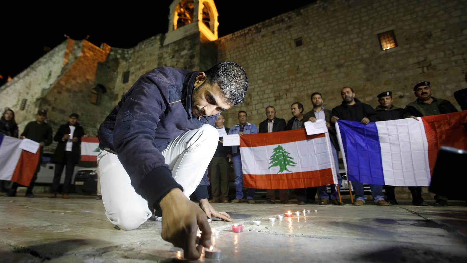 A Palestinian lights a candle  in solidarity with victims of attacks in Paris and Lebanon.