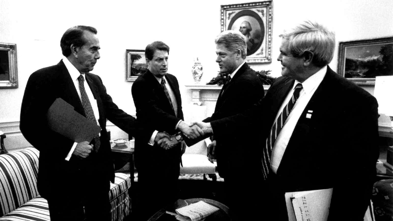 Republican Senate leader Bob Dole, Democratic Vice President Al Gore, Democratic President Bill Clinton and Republican Speaker of the House Newt Gingrich perform a complicated fiscal handshake. Those were the days…