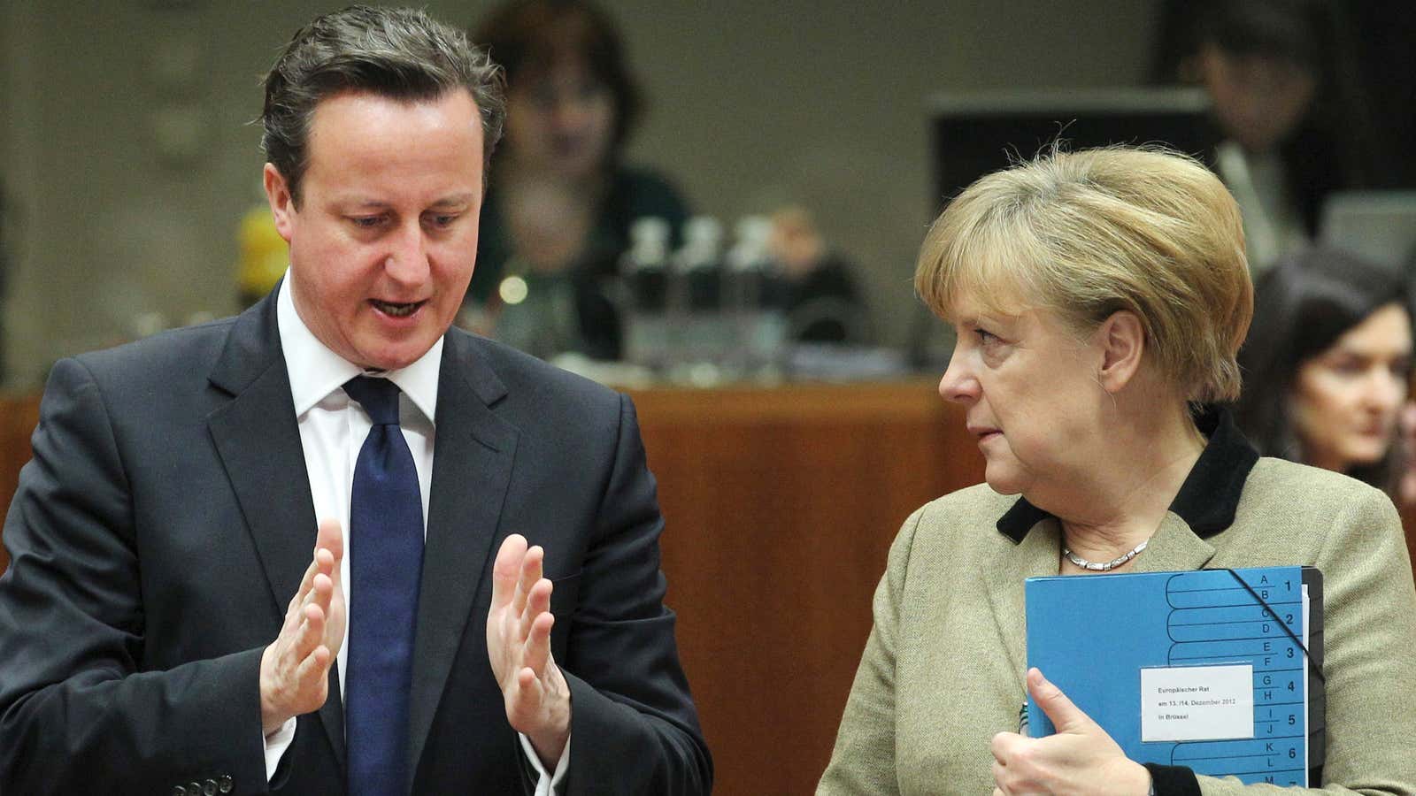 David Cameron shows Angela Merkel his plan for making the EU a little smaller.