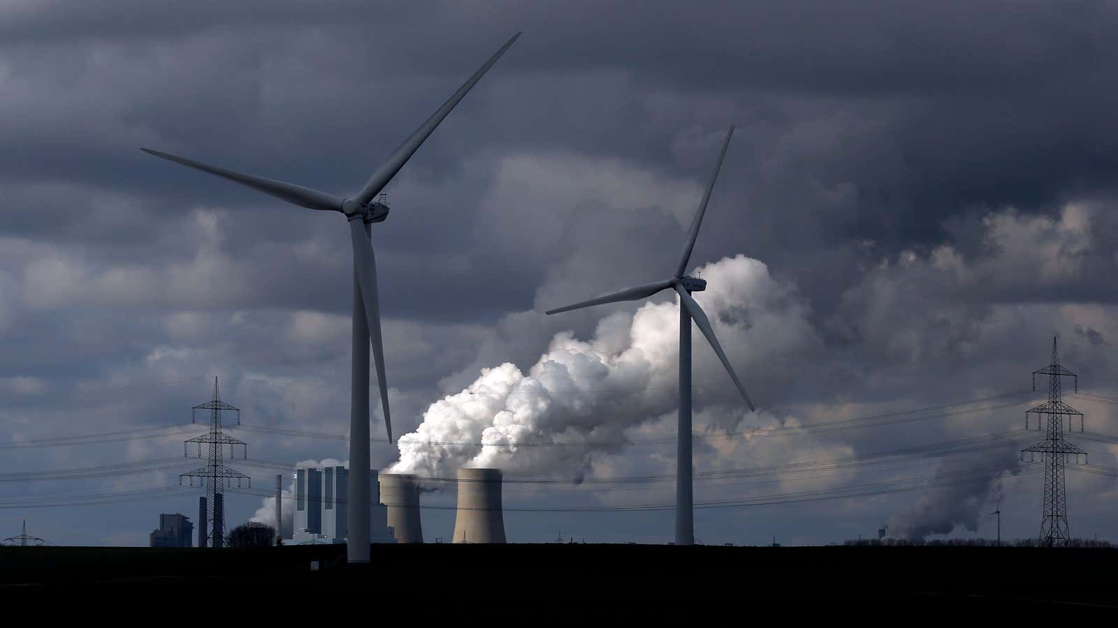 Wind turbines are seen in front of a coal power plant of German utility RWE Power near the western town of Neurath February 28, 2014.…