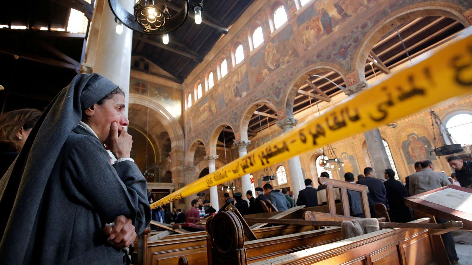 A nun cries as she stands at the scene inside Cairo’s Coptic cathedral, following the Dec. 11 bombing,