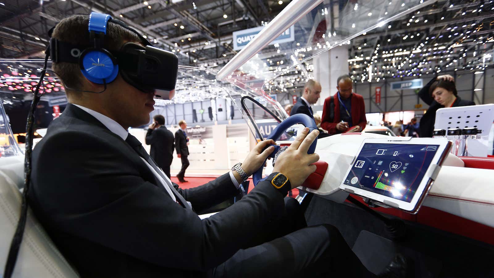 An employee sits inside a virtual reality connected car cockpit built by Segula Technologies during the first press day ahead of the 85th International Motor…