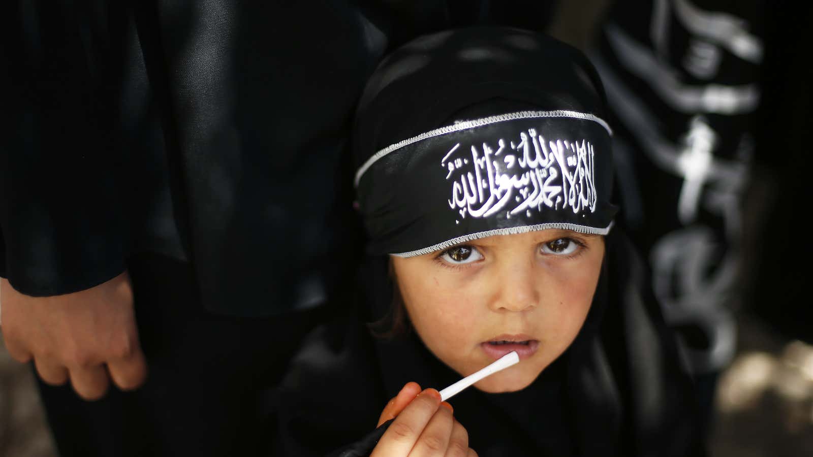 A Palestinian girl wearing the headband of Hizb ut-Tahrir takes part in a rally calling for Khilafah, or Islamic rule, in Gaza City, June 2013.