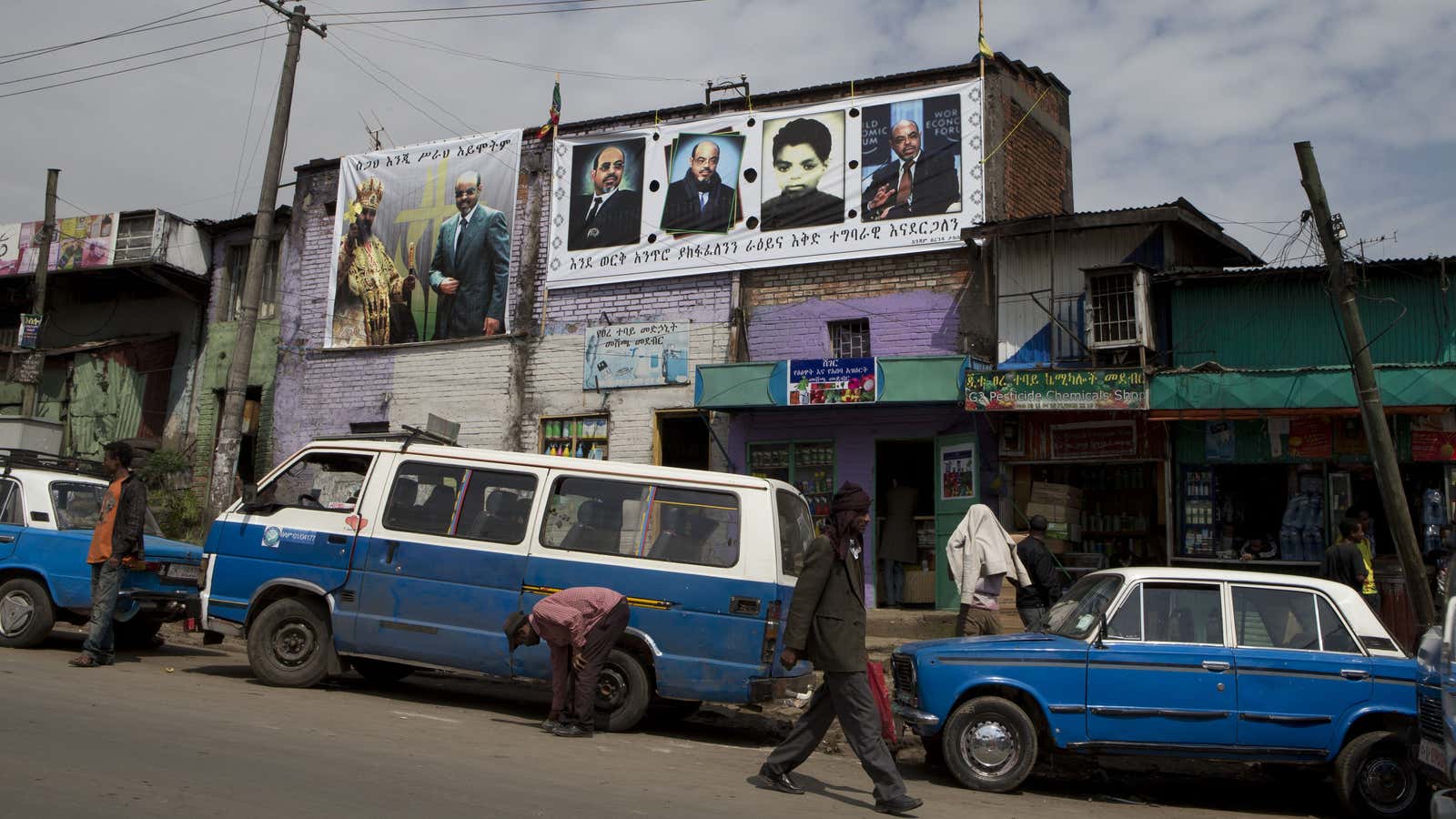 Taxis and a public transport minibus sit parked along an Addis Ababa street in 2012.