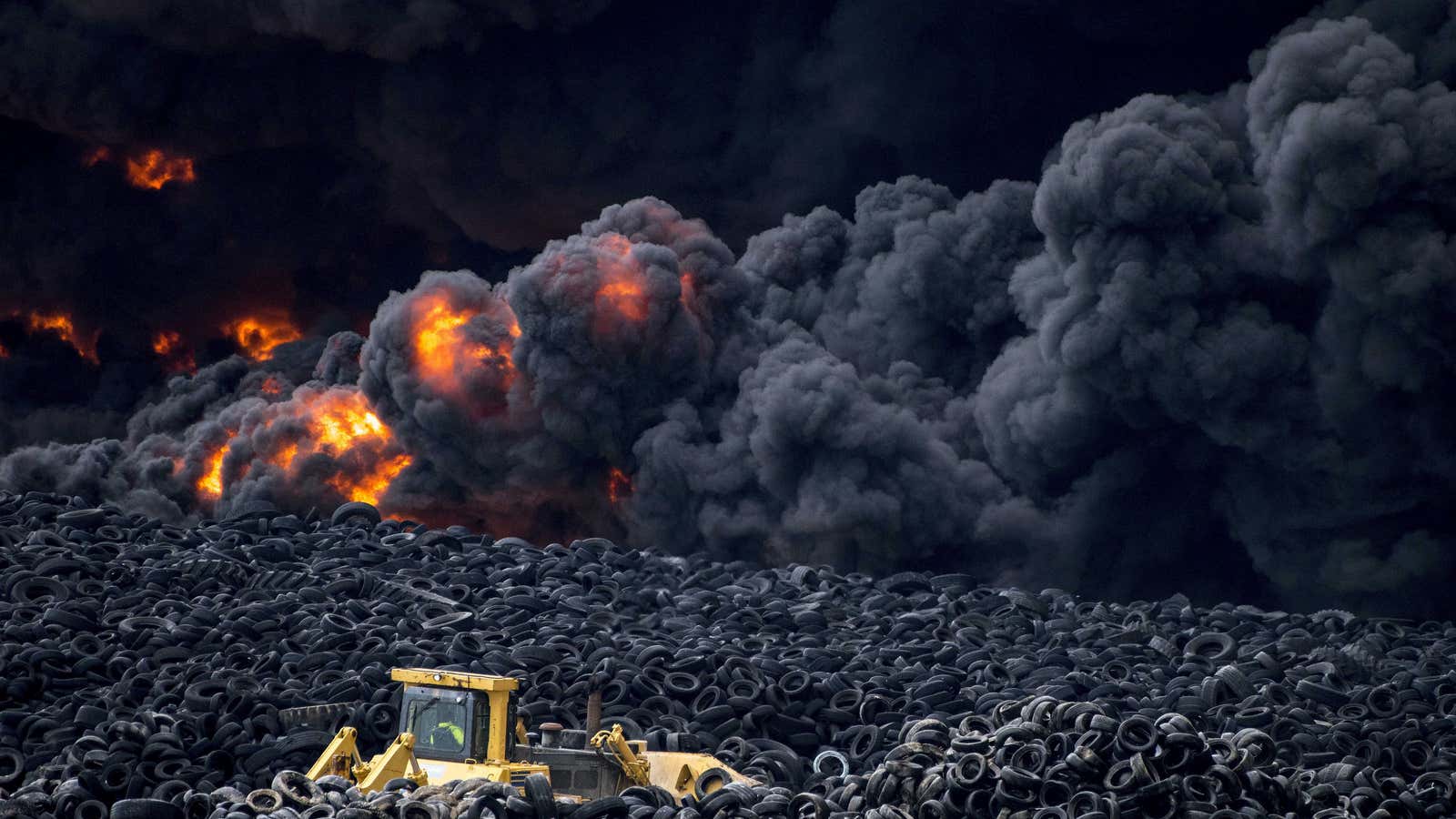 Photos capture plumes of smoke caused by a raging fire at a tire dump in Toledo, Spain.