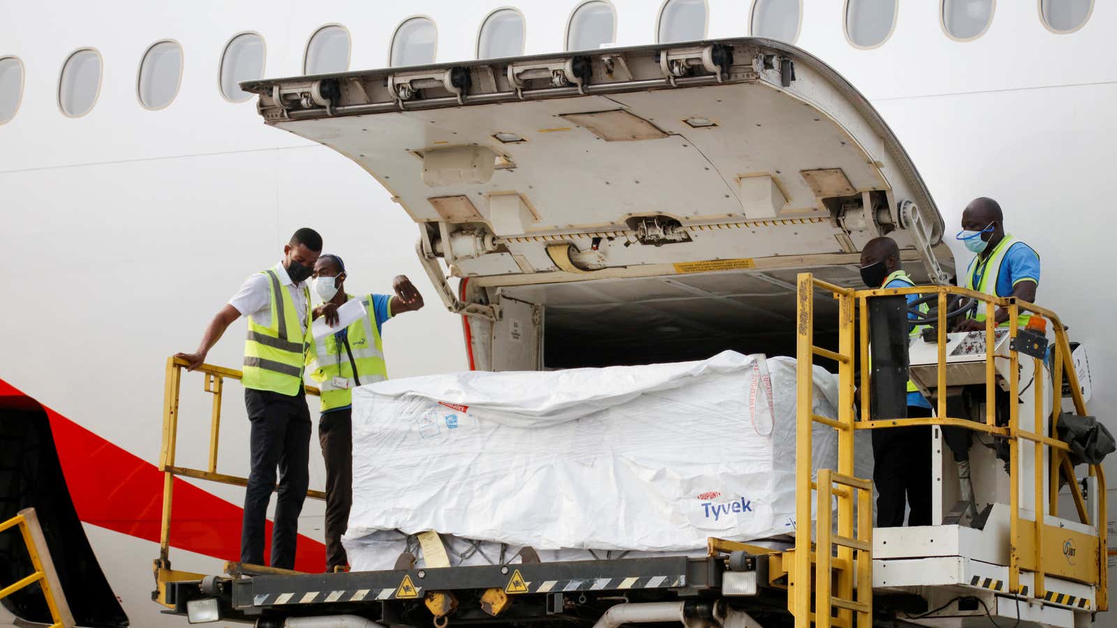 Workers offload AstraZeneca/Oxford vaccines as Ghana receives its first batch of Covid-19 vaccines under the Covax scheme on Fe. 24.