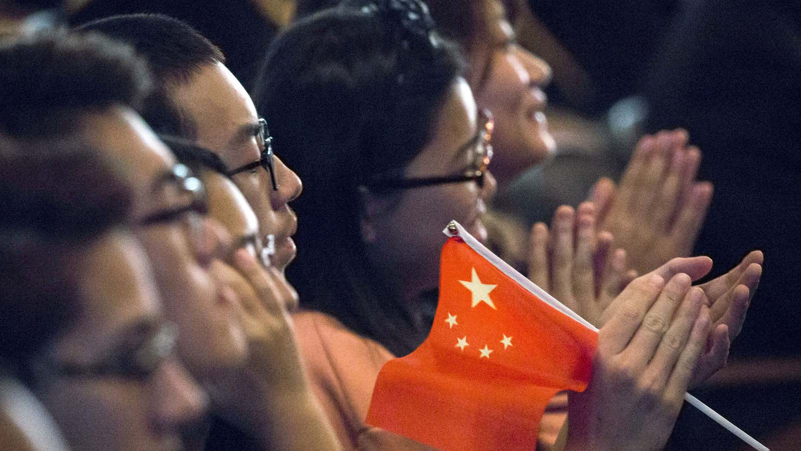 Chinese students listen to a speech by Xi Jinping.
