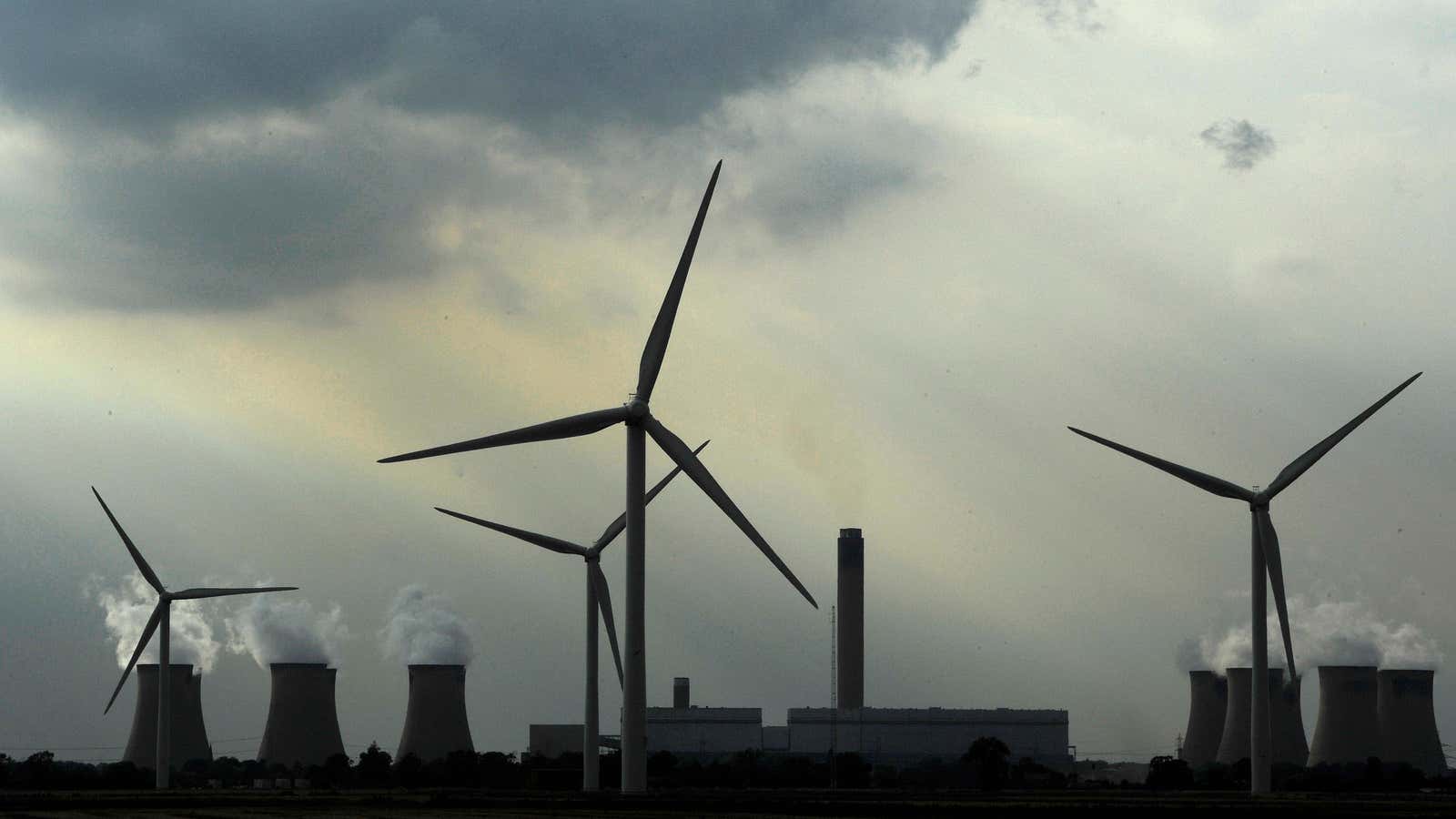 Wind turbines in front of the Drax coal and biomass power station, UK. 