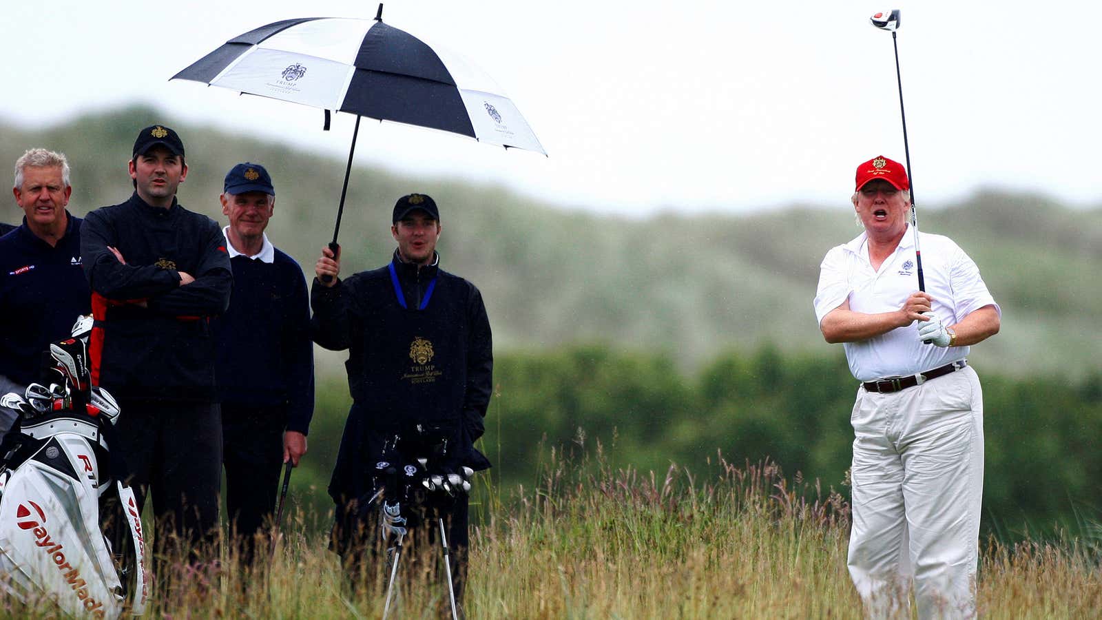 Trump plays at the opening of his loss-making course in Aberdeen, Scotland in 2012.