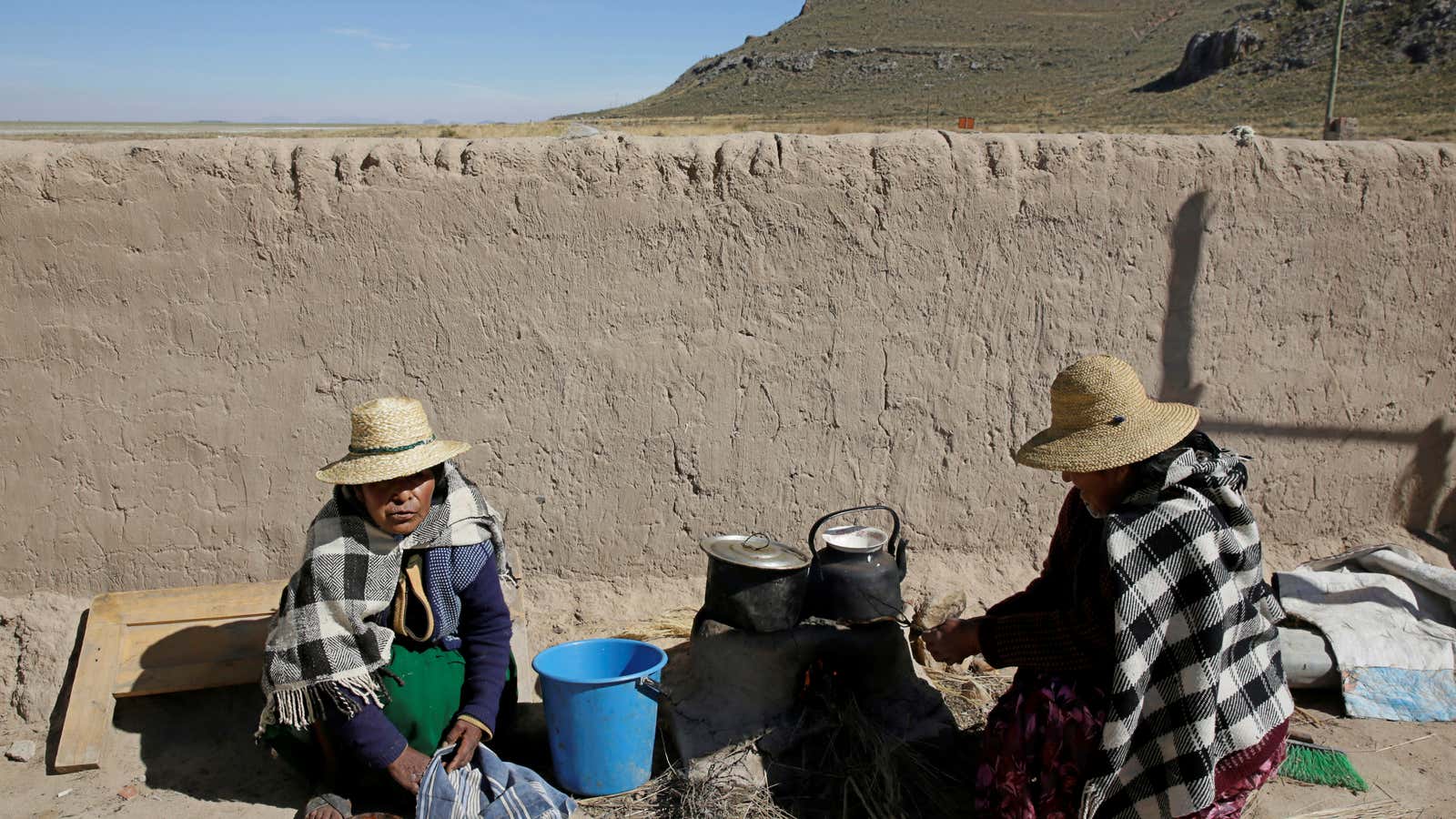 Urus Muratos women cook in Punaca on the shores of the dried lake Poopo affected by climate change in the Oruro Department, Bolivia.