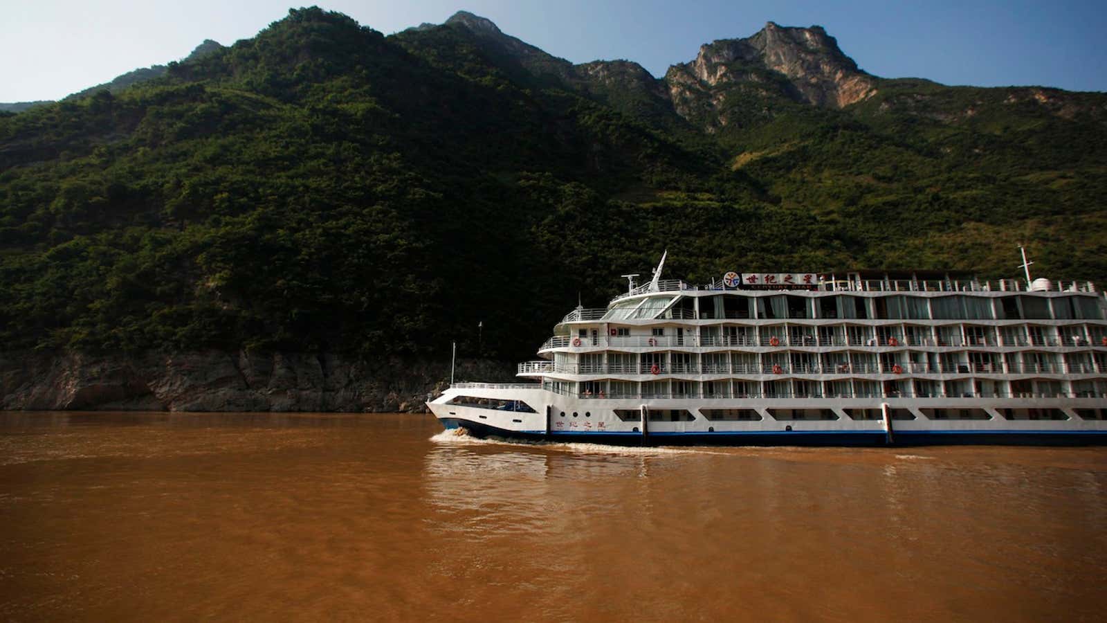A cruise ship sails on the Yangtze River near the Three Gorges dam in Hubei province.