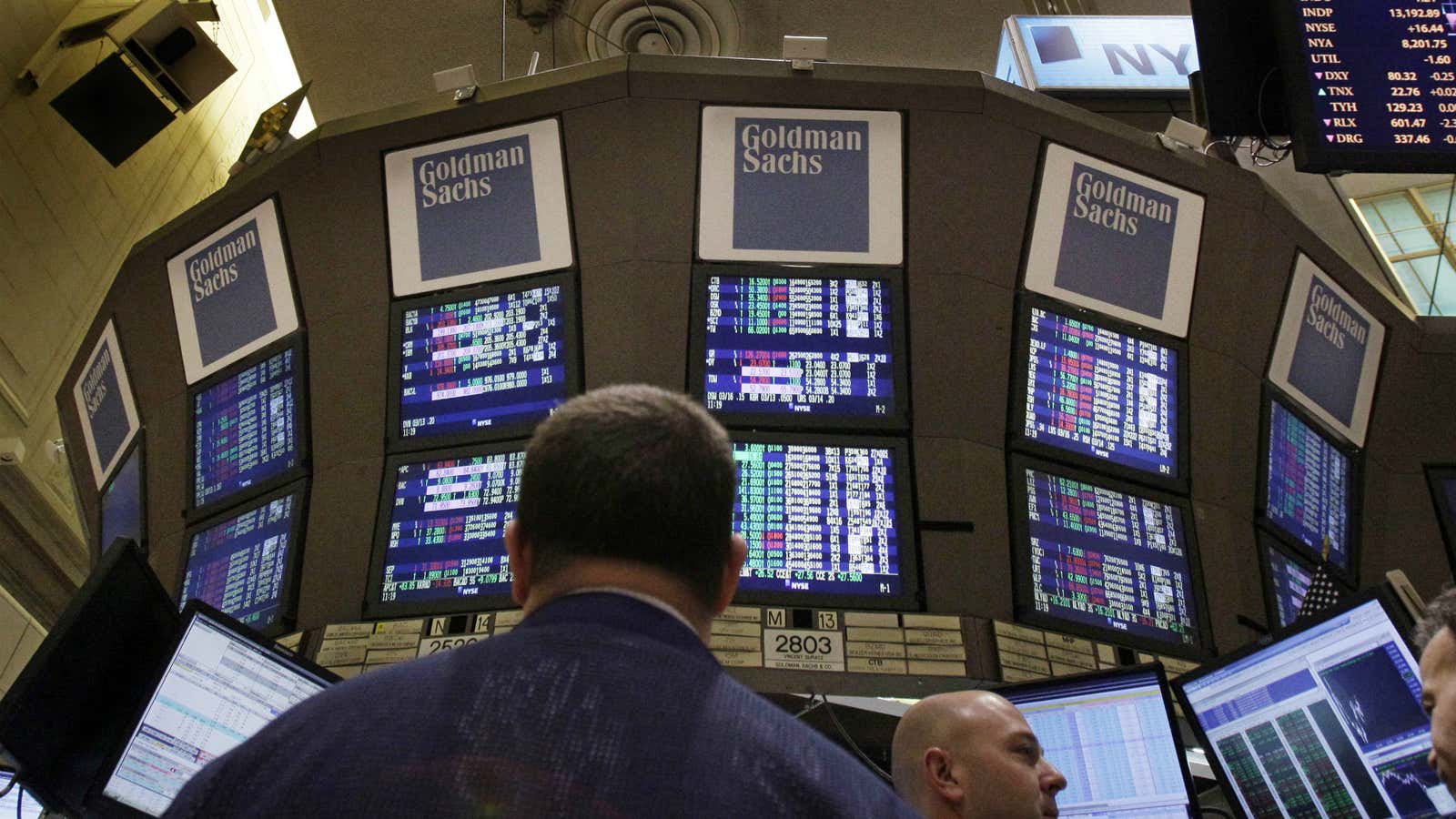 Traders work at the Goldman Sachs posts on the floor of the New York Stock Exchange Thursday, March 15, 2012.