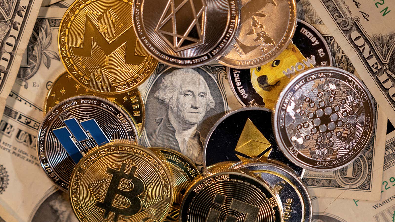 FILE PHOTO: Representations of virtual cryptocurrencies are placed on U.S. Dollar banknotes in this illustration taken November 28, 2021. REUTERS/Dado Ruvic/Illustration/File Photo/File Photo