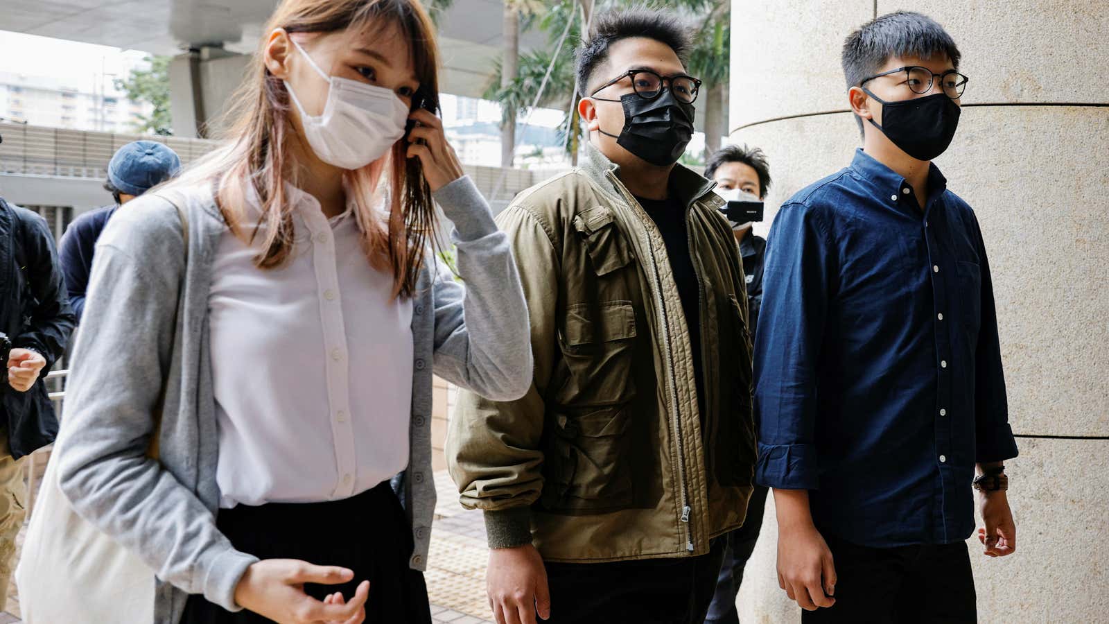 Pro-democracy activists Ivan Lam, Joshua Wong and Agnes Chow arrive at the West Kowloon Magistrates’ Courts to face charges related to illegal assembly stemming from…