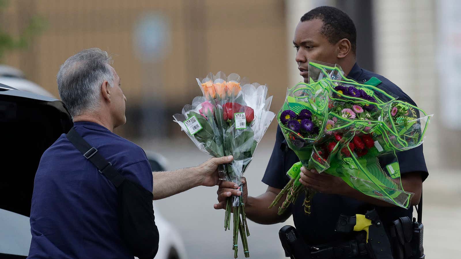 A Dallas police officer receivers flowers at a roadblock.
