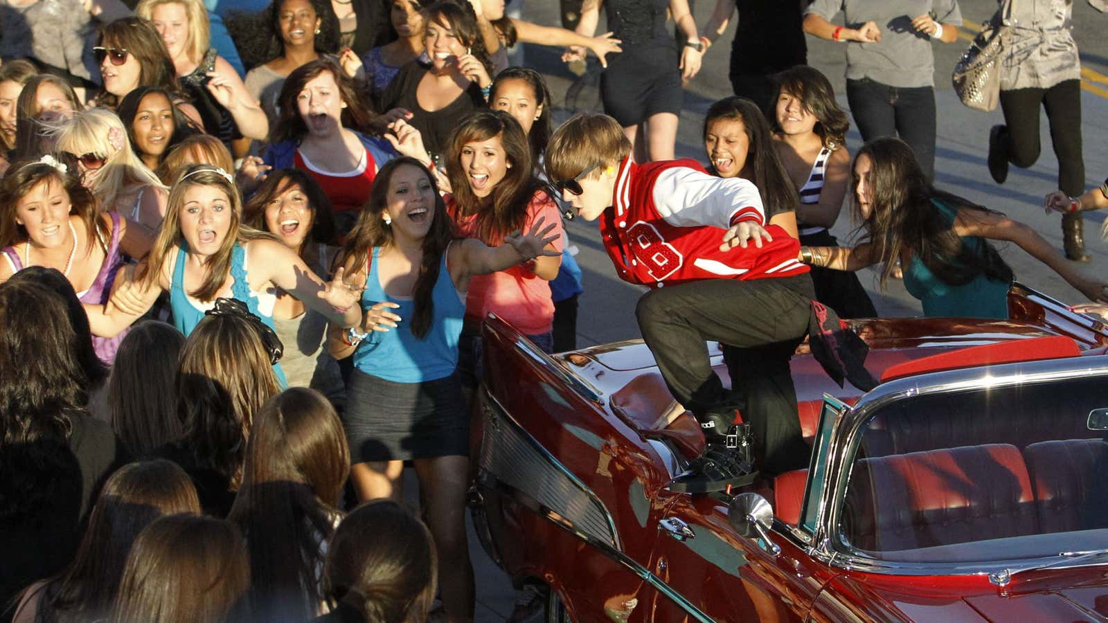 Justin Bieber jumps out of a car during a 2010 performance.